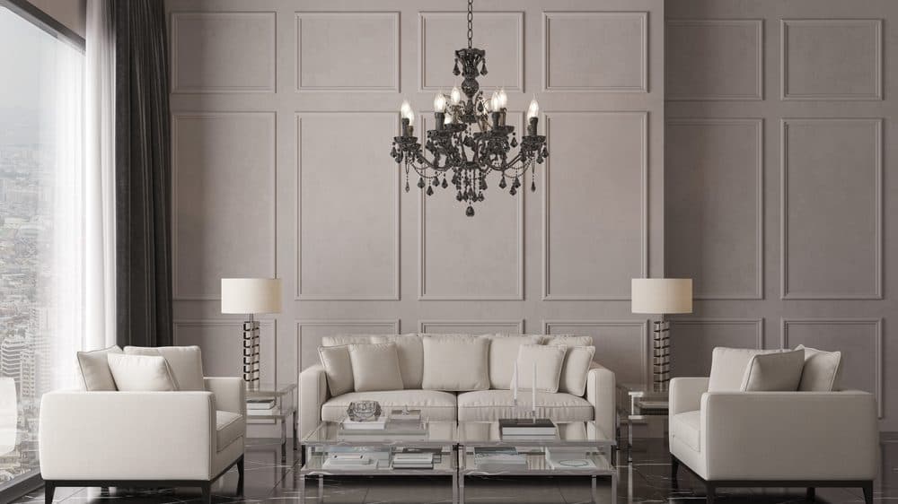 An all-white living room decorated in an upscale way with an eye-catching hanging chandelier