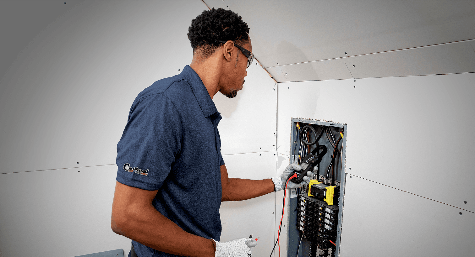 A man checks an electrical panel