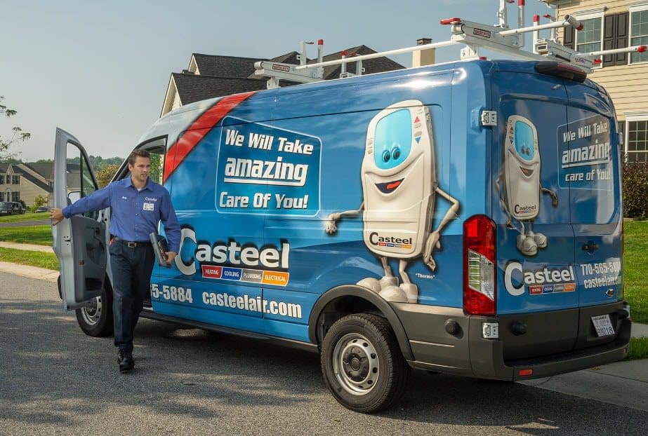 A Casteel technician getting out of his truck to go help a customer in their home