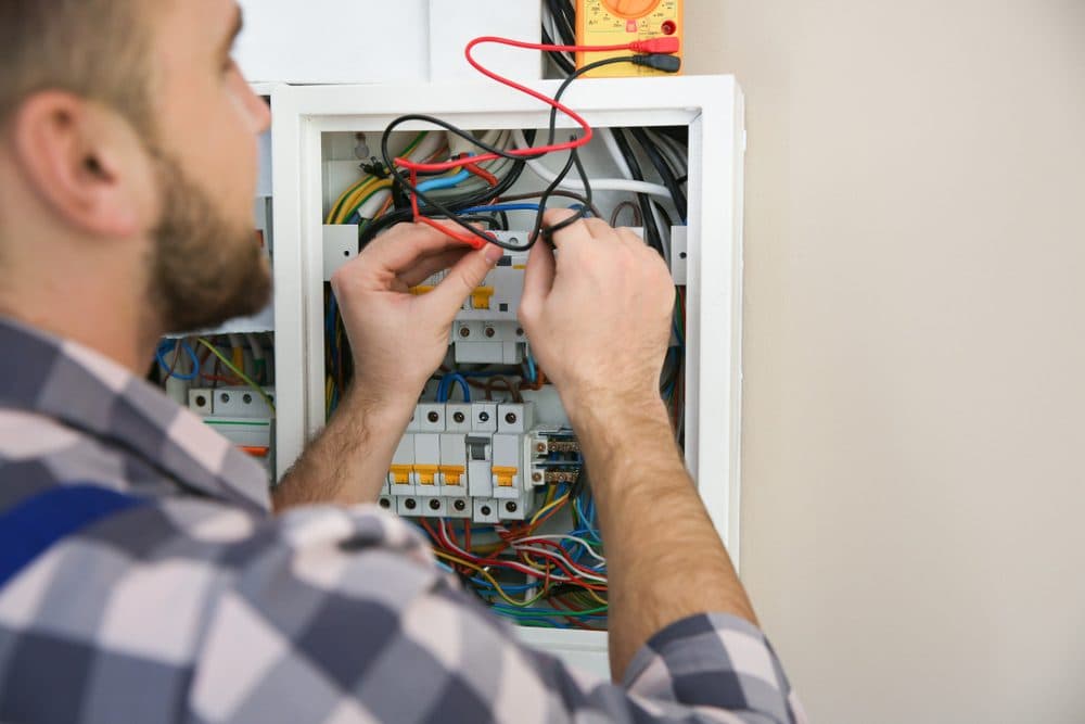 Casteel technician installing an electrical panel
