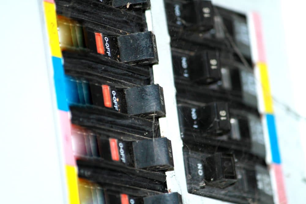 Up close focus on circuit breakers with red, blue, and yellow coloring