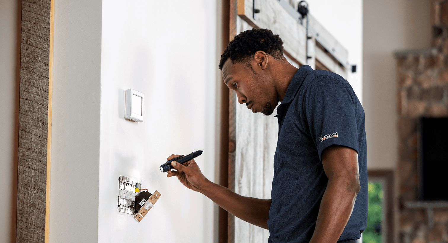 Technician looking at an electric outlet