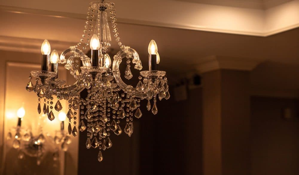 A glass chandelier hanging from the ceiling
