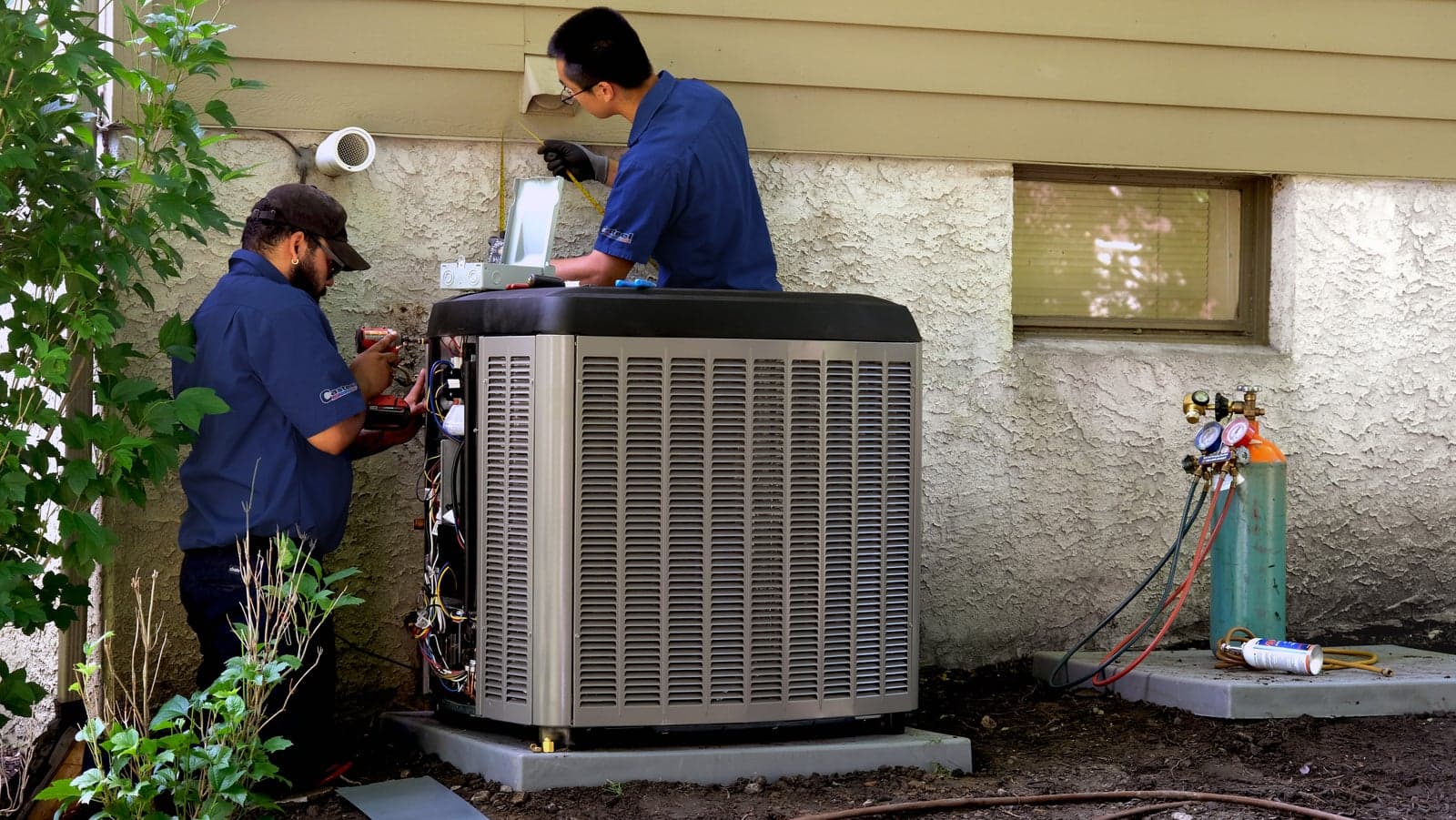 Casteel technicians installing a new high-efficiency air conditioning system