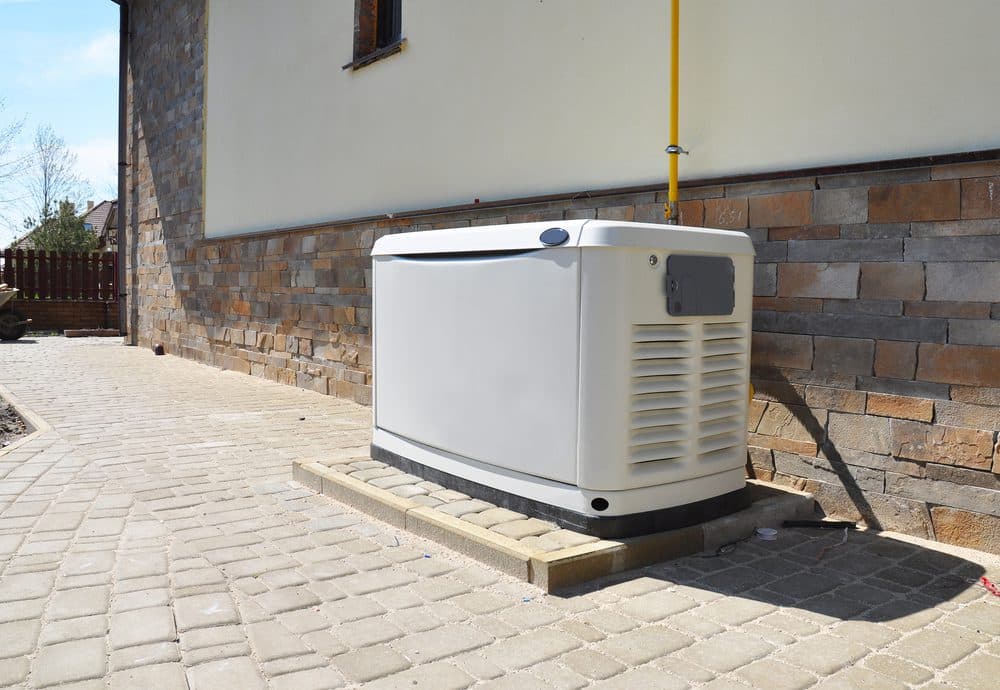 A generator sitting outside next to a house
