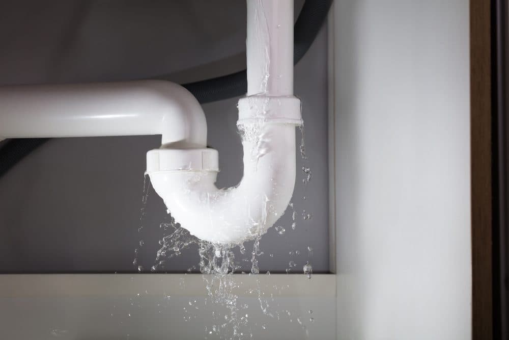 A water pipe leaking water from its connecting pieces