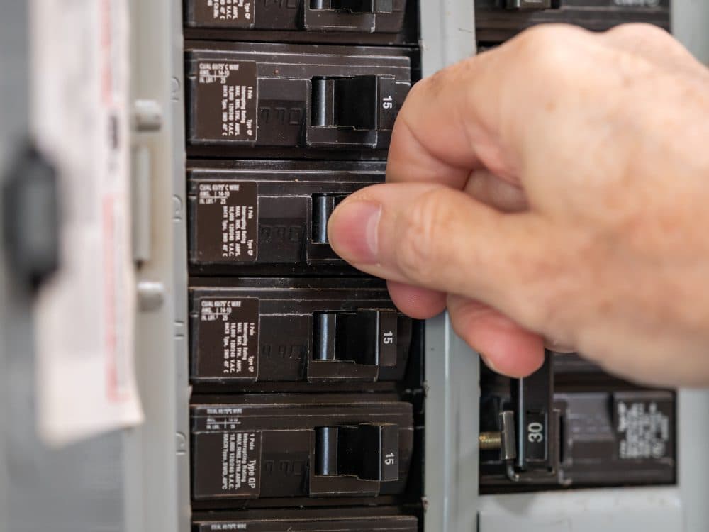 Hand flipping a circuit breaker