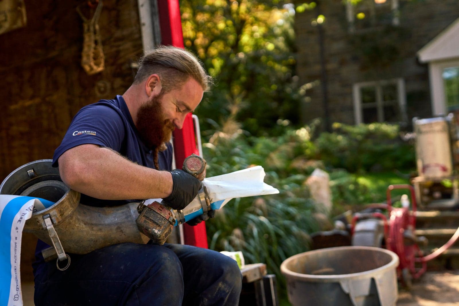 A Casteel technician preparing pipe liner during a trenchless sewer repair