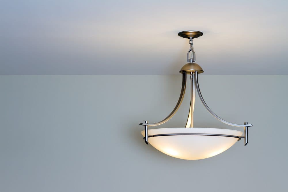 A simple light fixture hanging down that appears to be dimmer than expected