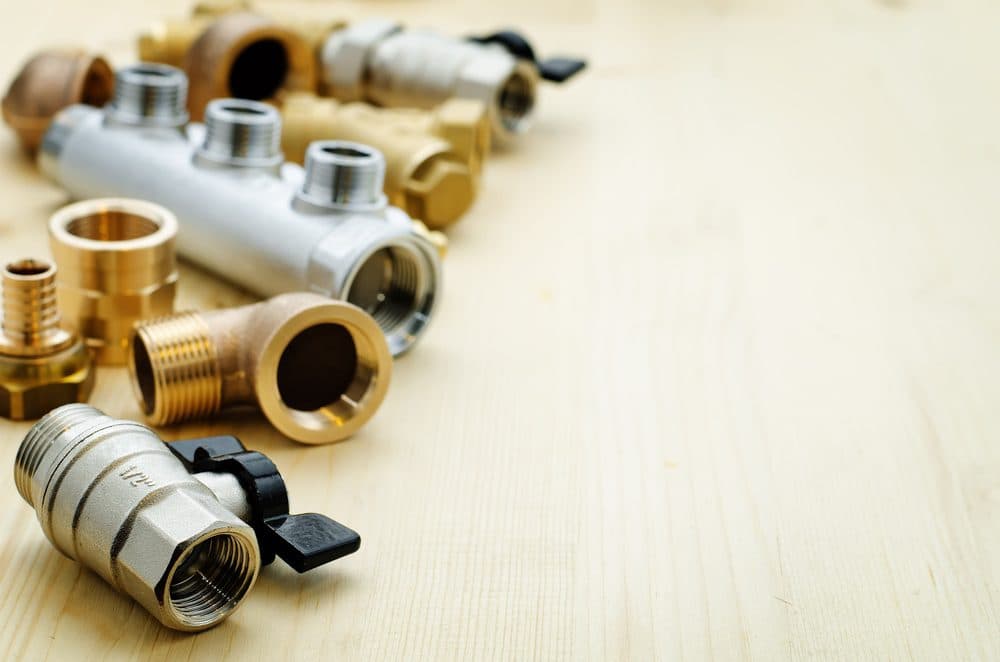 A variety of pipe fittings laying on a table top