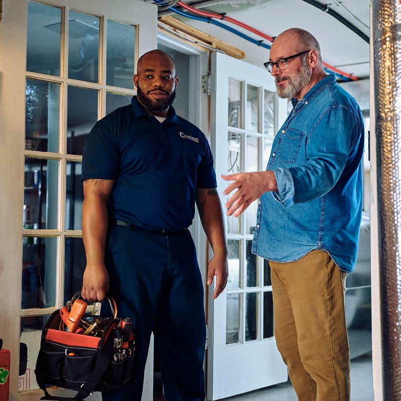 A Casteel technician discusses the repair and installation services with a homeowner.